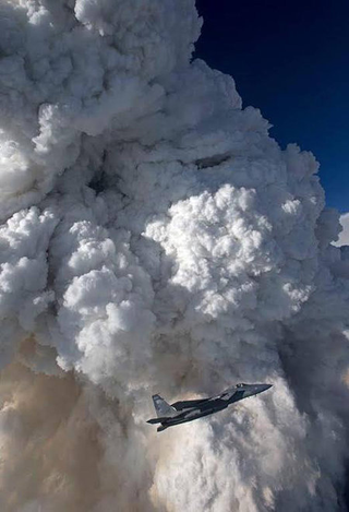 Illustration for article titled These Photos Of F-15s Flying Near Towering Forest Fires Are Totally Nuts